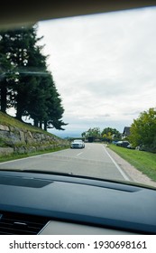 Switzerland - Sep 22, 2018: Driver POV At Car View At The Front Driving Mustang Sport Electric Car - Driving On Rural Highway Surrounded By Tall Fir Trees - Tilt-shift Photo