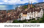 Switzerland travel and scenic places. Aerial drone view of Neuchatel charming town and impressive medieval castle overlooking the lake