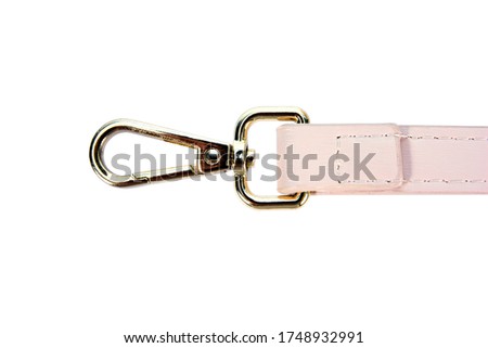 Swivel lobster clasp snap hook clip with leather shoulder bag strap isolated on white background. Metal swivel clip snap hook or gold trigger webbing bag hook isolated