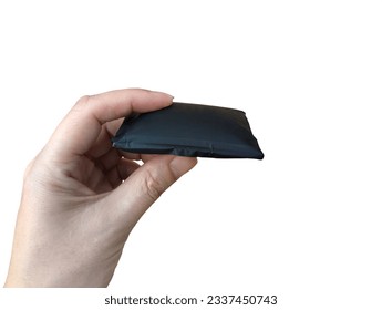 Swollen battery due to deterioration and a risk of explosion, Hand holding a damaged cell phone battery isolated on white background