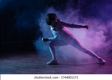 Swordswoman Fencing With Rapier On Black Background With Colorful Smoke