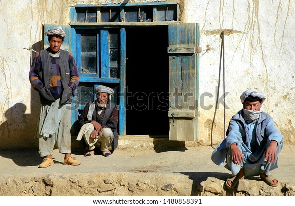 Syadara (Siyah Darah), Bamyan (Bamiyan)\
Province / Afghanistan - Aug 21 2005: Three Afghan men with turbans\
outside a house in the town of Syadara in Central Afghanistan. Men\
in a village,\
Afghanistan