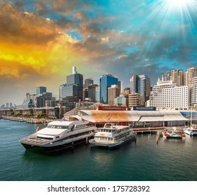 Sydney. Aquarium Ferry Wharf And City Skyline At Dusk.