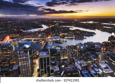 Sydney Australia Aerial View From Sydney Tower At Sunset With Orange Sky And Clouds At City With Illuminated Skyscrapers