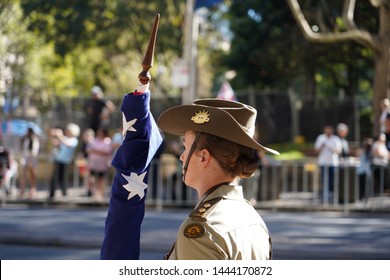 Sydney, Australia - April 25, 2019: Australian Army Officer Stands With The Australian Flag During The ANZAC Parade.