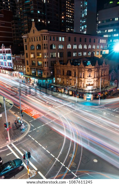 SYDNEY, AUSTRALIA - APRIL 5,\
2018: Night street view of car trails at Elizabeth St in Sydney\
CBD.