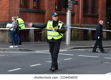 Sydney, Australia - August 13, 2019: A Police Officer Directs Traffic At A Crime Scene In The City's CBD.