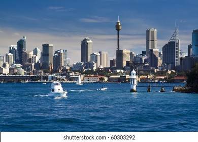 Sydney Australia CBD Close-up With Lighthouse And Boat In Harbour Water Blue Sky Skyscrapers