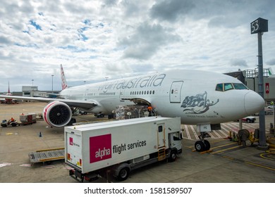 Sydney, Australia - Dec 22, 2017: Virgin Australia Plane Docked At Terminal 53 Of Kingsford-Smith International Airport. Ground Crew Loading And Unloading Various Flight Services Or Cargoes.