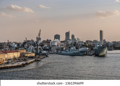 Sydney, Australia - February 12, 2019: Several Large Navy Ships At Royal Australian Navy Heritage Centre With Housing In Back Under An Evening Twilight Sky.