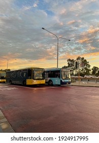 Sydney, Australia - February 25, 2021: Yellow And Blue Coloured Buses Under The Sunset Sky.