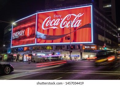 SYDNEY, AUSTRALIA - JULI 1st, 2019: The Refurbished Coca Cola Sign On Kings Cross, Sydney Together With An Ad For The New Coke Energy Drink.