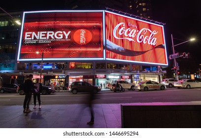 SYDNEY, AUSTRALIA - JULY 1st, 2019: The Refurbished Coca Cola Sign On Kings Cross, Sydney Together With An Ad For The New Coke Energy Drink.