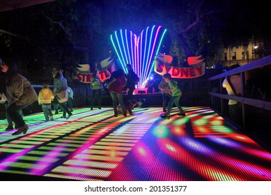 SYDNEY, AUSTRALIA - JUNE 2, 2014;  Vivid Sydney Festival,families enjoy the Strictly Sydney interactive disco dance floor.  Image has grain