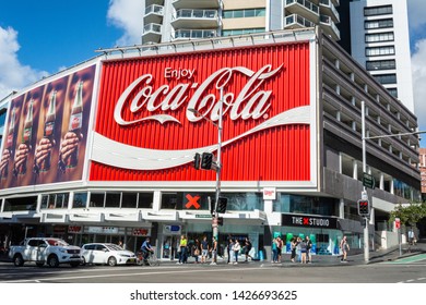 Sydney, Australia - March 10, 2017. The Coca-Cola Billboard In Kings Cross, Sydney, With Commercial Properties And People, At Daytime.