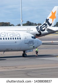 Sydney, Australia - May 11, 2019: A Man Standing Below Virgin Australia Aircraft Nose.