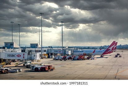 Sydney, Australia - May 18, 2019: Qantas Airlines Planes Docked At Jetways Of Kingsford-Smith International Airport. Preparation Ground Crew Loading And Delivering Various Flight Services And Cargoes.