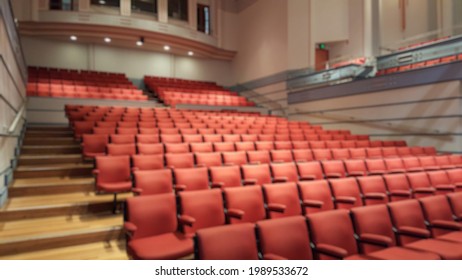 Sydney, Australia - May 2021: Blurry Vision View Of Rows Of Empty Red Armchair In The Auditorium Or Theater Or Hall With Bright Light. 