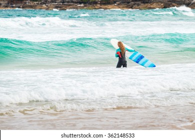 Sydney, Australia - November 8, 2015: Surfer Girl Entering The Waters Of Bondi Beach. Bondi Beach Is One Of The Most Famous Places For Surfing In Australia