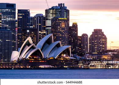 Sydney, Australia - September 16, 2016: The Iconic Sydney Opera House, Landmark Of The City, With The Skyline In Sydney, Australia. Front View After Sunset. 