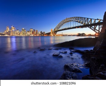 Sydney City Cbd And Harbour Bridge View At Sunset With Illumination Of Lights At Low Tide Australia