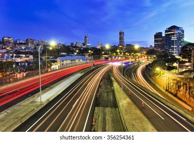 Sydney City Domain Suburb At Sunset View Above Cross-city Toll Road Motorway When Car Headligths Are Blurred And Buildings Are Illuminated