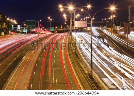 Sydney city motorway at sunset with blurred long exposure traffic vehicles lights and motion rush hour