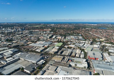 Sydney Cityscape Aerial View. Sydney Suburbs With Warehouses, Commercial And Residential Property From Above, Panoramic Drone View. Aerial Shot Of Modern City Urban Areas 