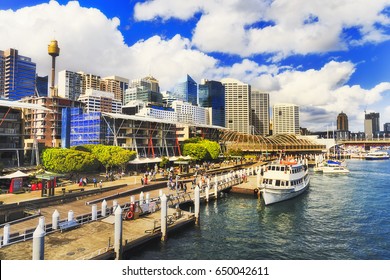 Sydney Darling Harbour Kings wharf with docked ship along the pier with modern architecture towers and skyscrapers on a sunny summer day.