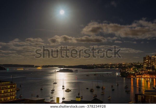 Sydney Harbor in the moonlight with water\
reflections - Long\
exposure