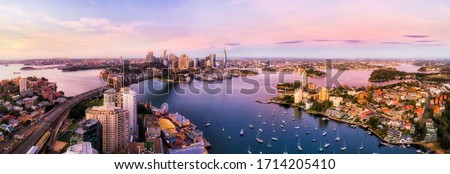 Sydney harbour and major city landmakrs around Lavender bay in aerial panorama at sunrise.