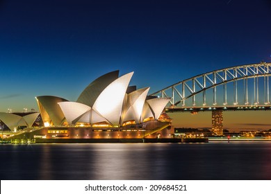 SYDNEY - MAY 16: Opera House and Harbor Bridge at twilight on May 16, 14 in Sydney. The two man made structures are considered as the major landmark of Sydney and tourists attraction.