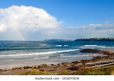 Sydney, New South Wales, Australia. June 2019. A Coastal View At Long Reef In Sydney With A Rainbow In The Background.