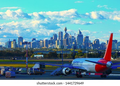 Sydney, New South Wales / Australia - July 02-2012: View from Kingsford Smith International Airport, Qantas plane with the Sydney cityscape in the background. Qantas is a well known airline.