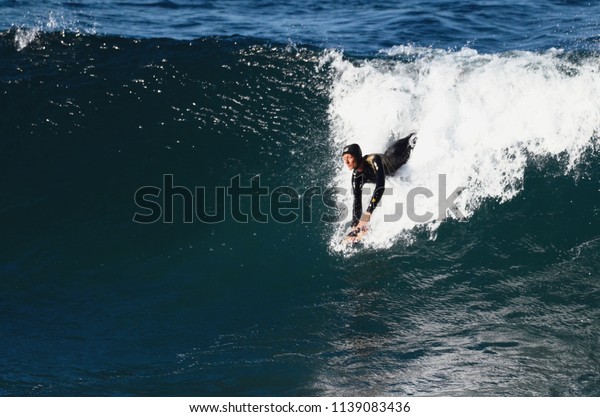 Sydney, New South\
Wales, Australia. July 2018. A woman body surfing at Cronulla Beach\
in Sydney\'s south.