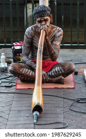 Sydney, New South Wales-Australia; 06-26-2021: Australian Aboriginal performing a street performance with traditional wind instruments in Sydney Harbor