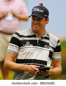 SYDNEY - NOV 11: American Golfer Nick Watney Smiles As He Records His Score During The Second Round In The Australian Open At The Lakes Golf Course. Sydney, November 11, 2011