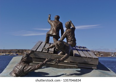 Sydney, Nova Scotia, Canada, 03.24.2019 sculpture showing merchant mariner in ocean facing blue sky - Shutterstock ID 1357046834