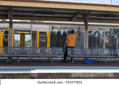 Sydney NSW, Austraila, February 26-2017. Man Cleaning Glasses At Train Station Public Transport Sydney NSW, Australia