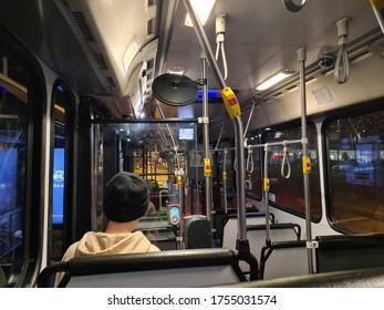 Sydney NSW Australia - 13 MAY 2020: Interior Of Sydney Public Transport Bus With Commuter. People Use Opal Cashless Card To Commute By Tap On And Off. Wheelchair Accessible Bus At Night Time