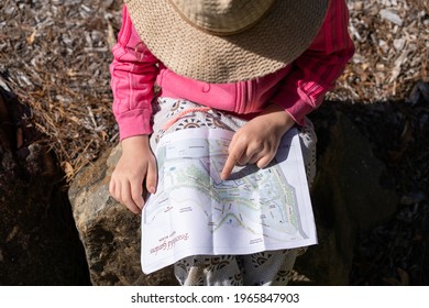 Sydney NSW Australia 25th April 2021: child looking up directions from a paper map