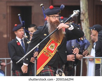 Sydney, NSW Australia - April 25 2021: People At The Anzac Day March. The Drum Major Of A Pipe Band Holding A Mace As He Marches. He Has A Long Beard.  Sydney City