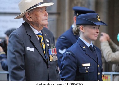 Sydney, NSW Australia - April 25 2021: Anzac Day March. An Older Veteran Marching With A Young Woman From The Air Force