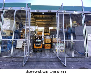 Sydney, NSW Australia - August 2 2020: Sydney Markets Supplies A Third Of Australia's Population With Fresh Produce. Pictured An Open Market Traders Storage Cage With A Toyota Forklift Truck In It