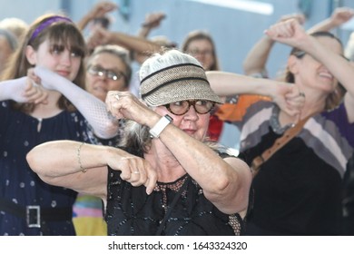 Sydney, NSW Australia - February 11 2020: Civil DiscoBedience Rally For Climate Change By The Greens NSW. A Group Of People Dancing Disco At The Rally. Senior Woman Doing Dance Moves At The Protest.