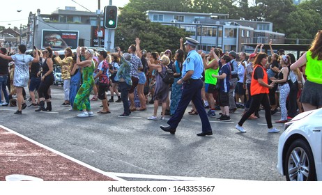 Sydney, NSW Australia - February 11 2020: Civil DiscoBedience Rally For Climate Change. Protestors Defy Traffic On Newtown's Busiest Intersection To Dance Across The Road, Then Police Arrived.