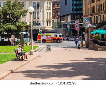 Sydney NSW Australia - February 21st 2021 - Hyde Park Entrance And Fire Truck Driving Past Background Blur On A Sunny Summer Afternoon