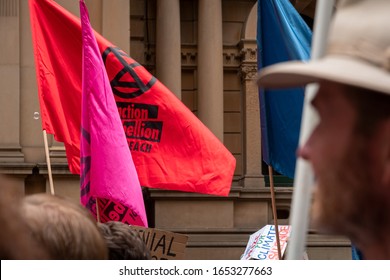 Sydney, NSW, Australia -February 22, 2020: Flags And Banners And People In Foreground In Depth Of Field At The Climate Crisis Protest Rally At Sydney Town Hall In Australia.