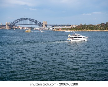 Sydney NSW Australia - January 26th 2020 -  Party Boat Sailing And Sydney Harbour Bridge On Australia Day 2020 On A Hazy Summer Afternoon Due To Bushfire