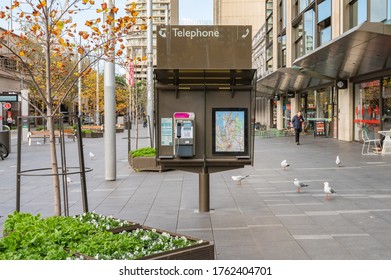 Sydney NSW Australia - June 18th 2020 - Public Telephone Booth and Sydney Maps at Alfred St on a sunny winter afternoon